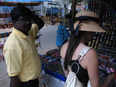 Raj helping Esther negotiate some bracelet prices at the market.